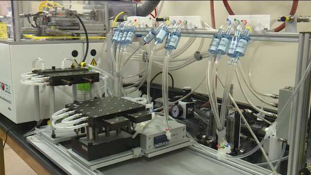automated vape testing machine, robot vaping test, scientific vape puff measurement equipment - Kansas City doctor uses vaping robot in research